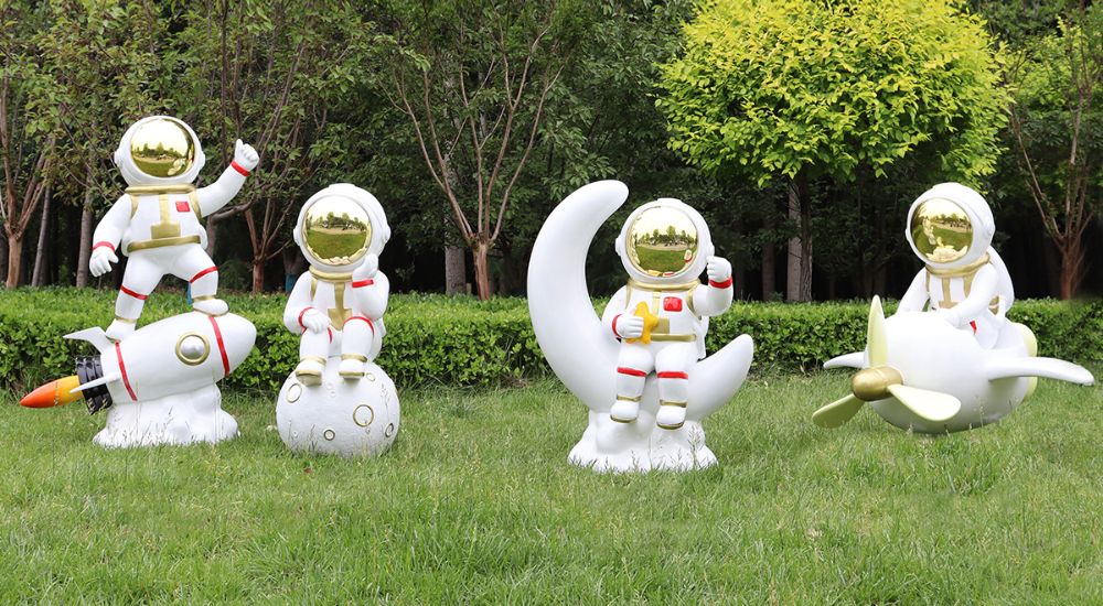 Different fiberglass astronaut sculptures