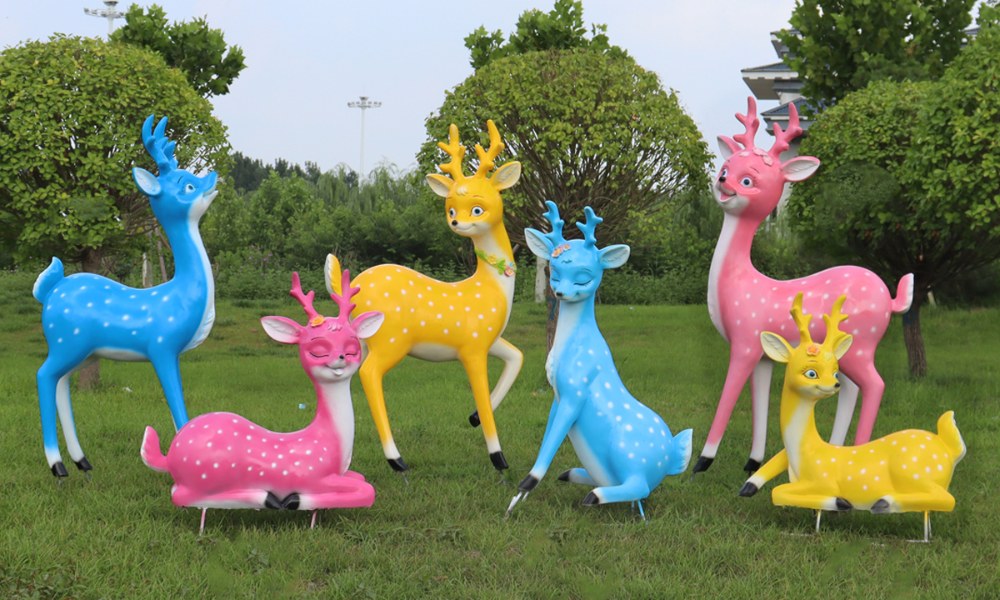 Colorful cartoon fiberglass deer sculptures