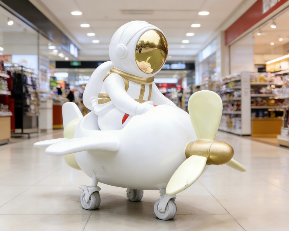 The shop displays resin astronaut sculptures.