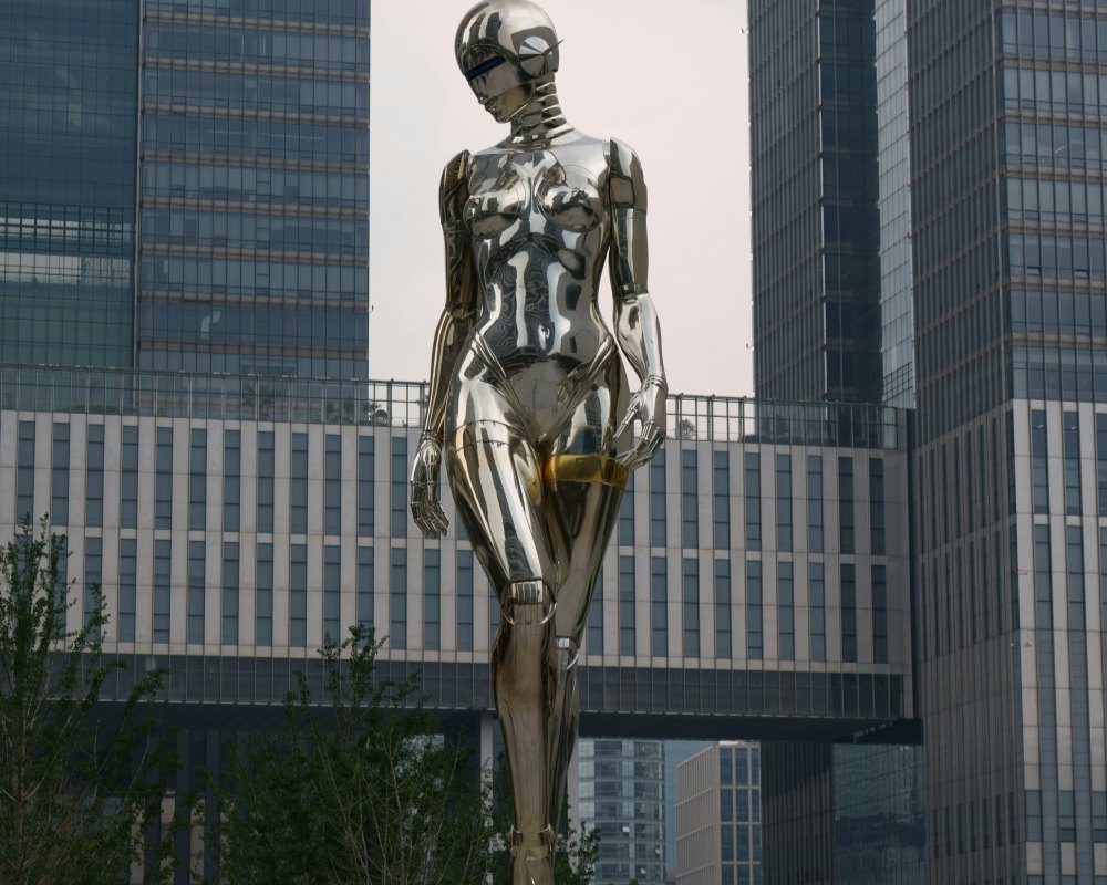 Large stainless steel human-shaped sculpture